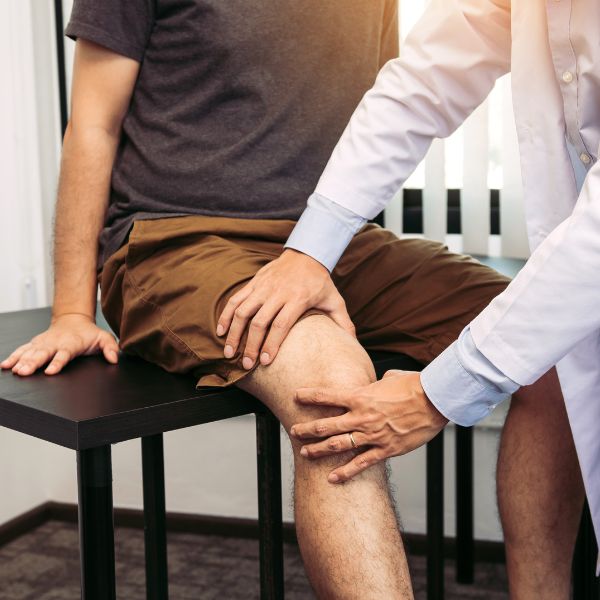 A doctor examining Knee of a patient