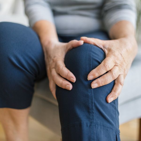 A man holding his injured Knee